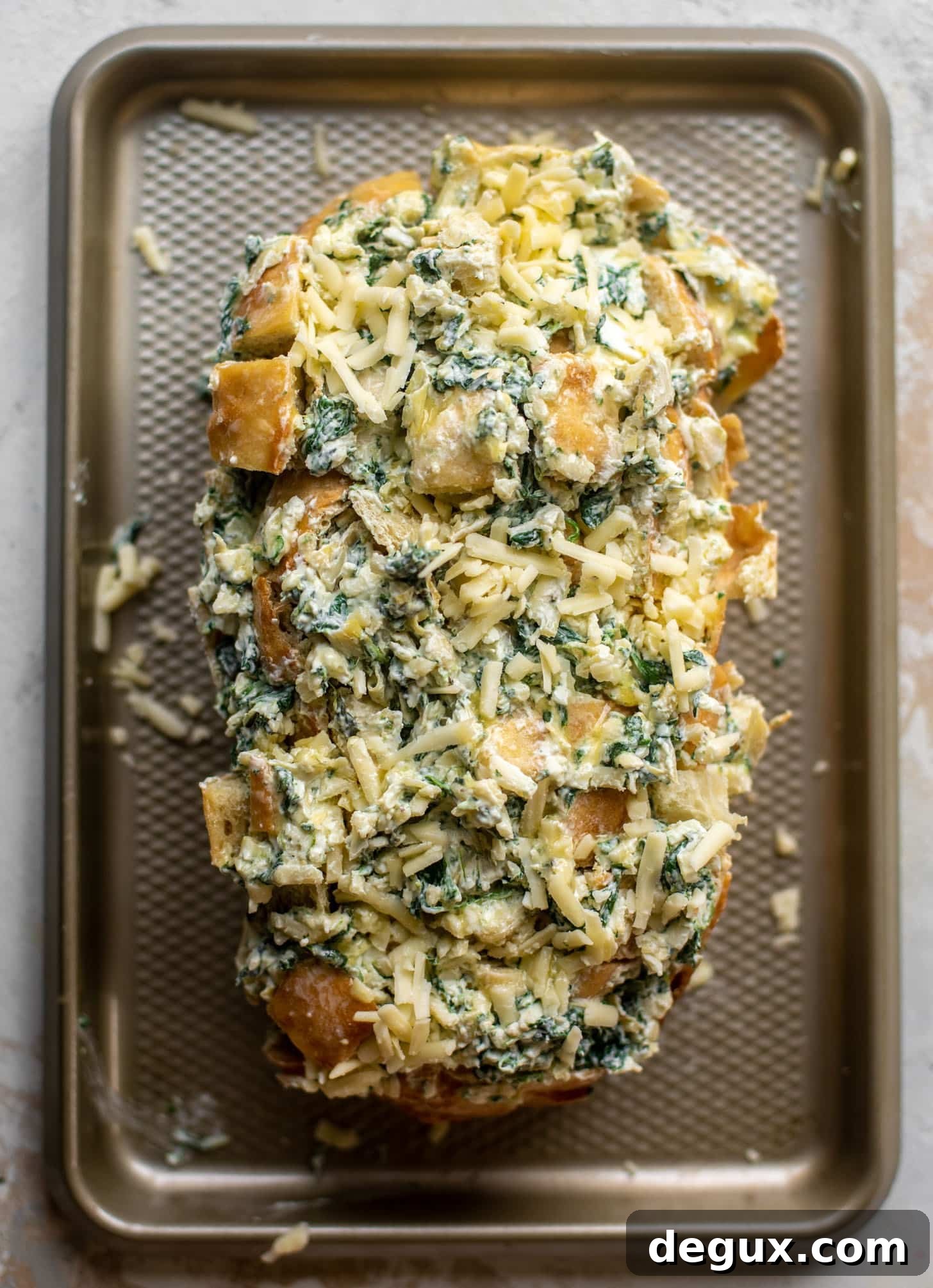bread sliced and stuffed with spinach artichoke dip