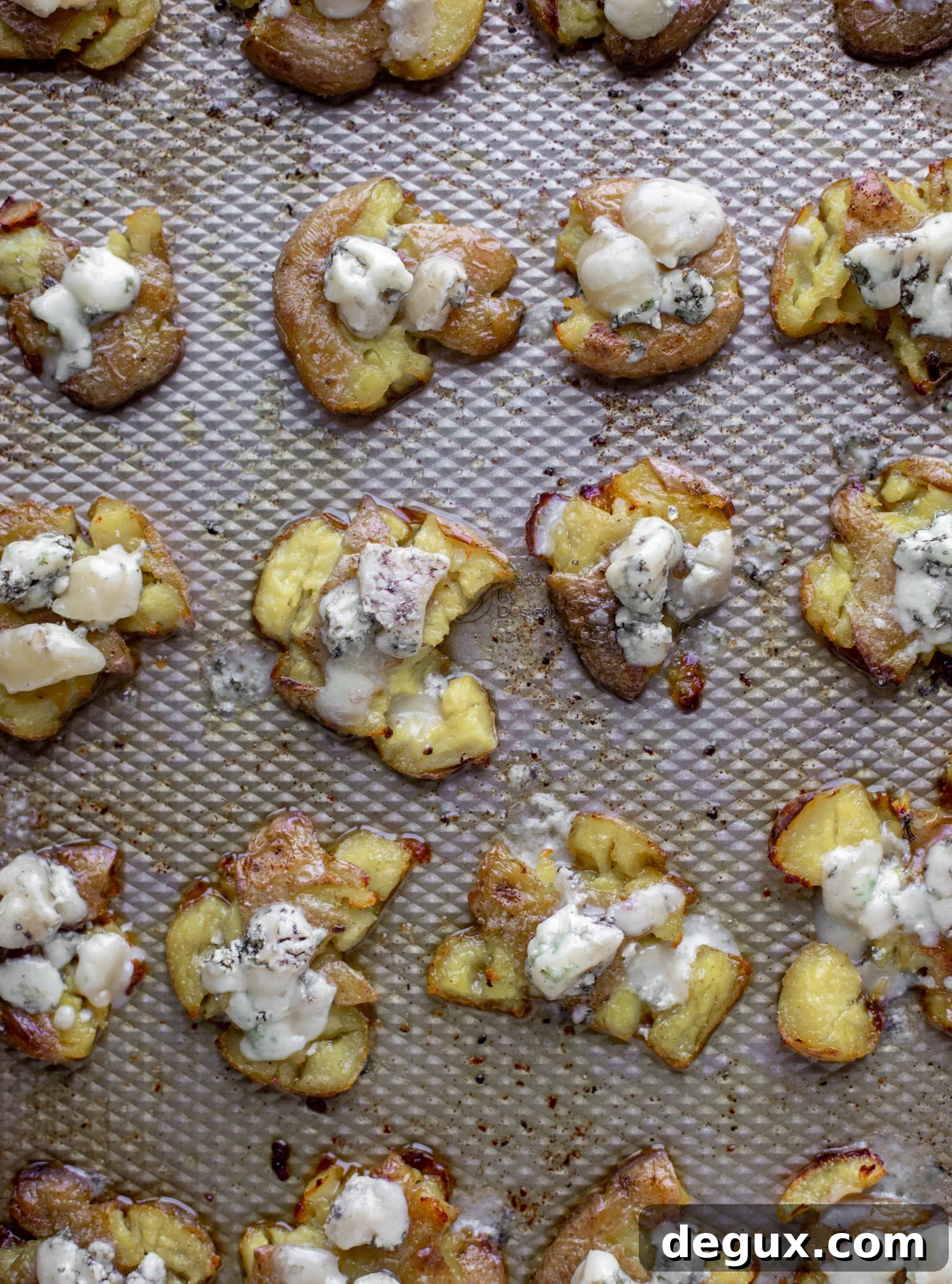 smashed potatoes on baking sheet with blue cheese