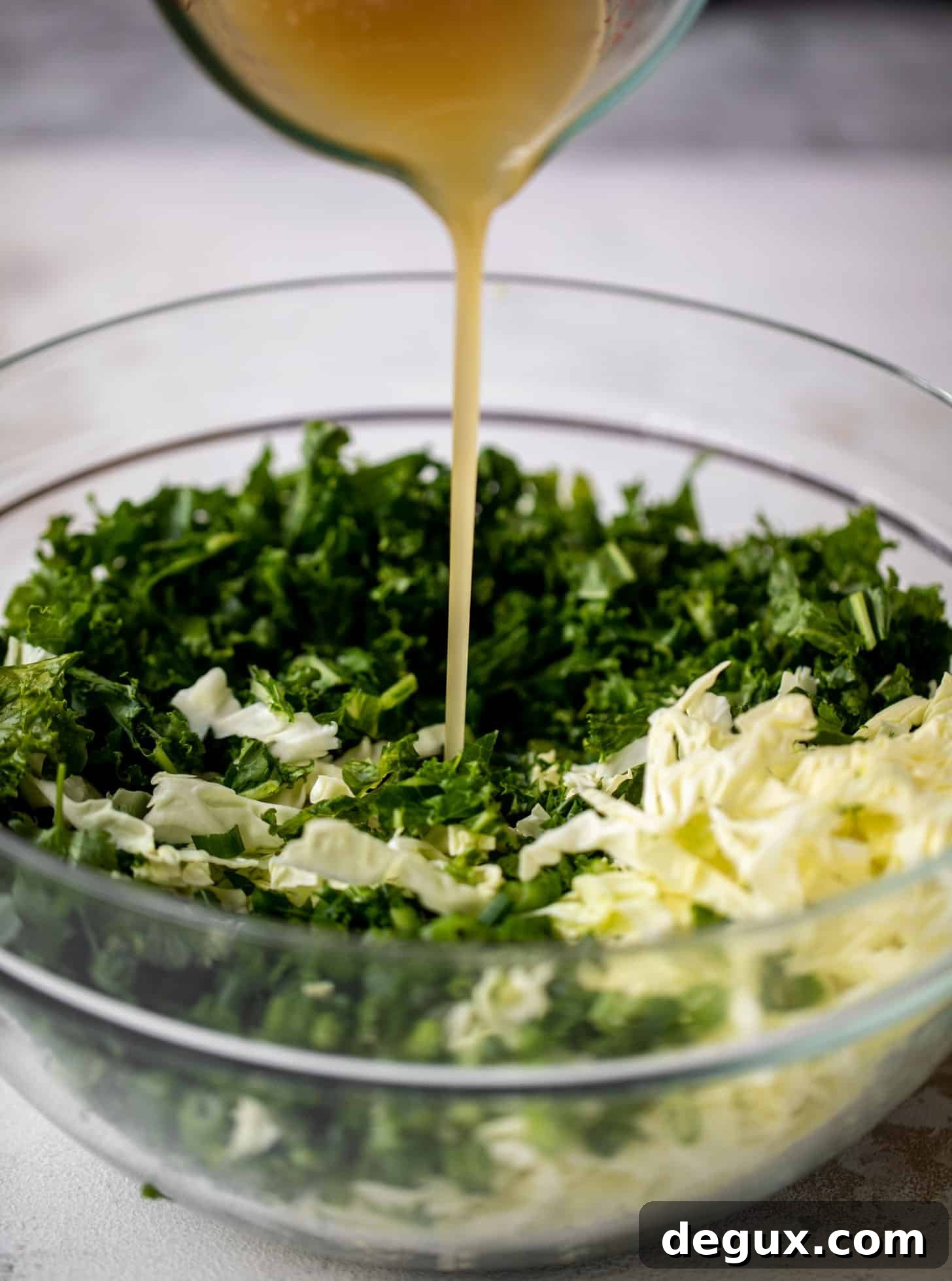 pouring dressing on salad