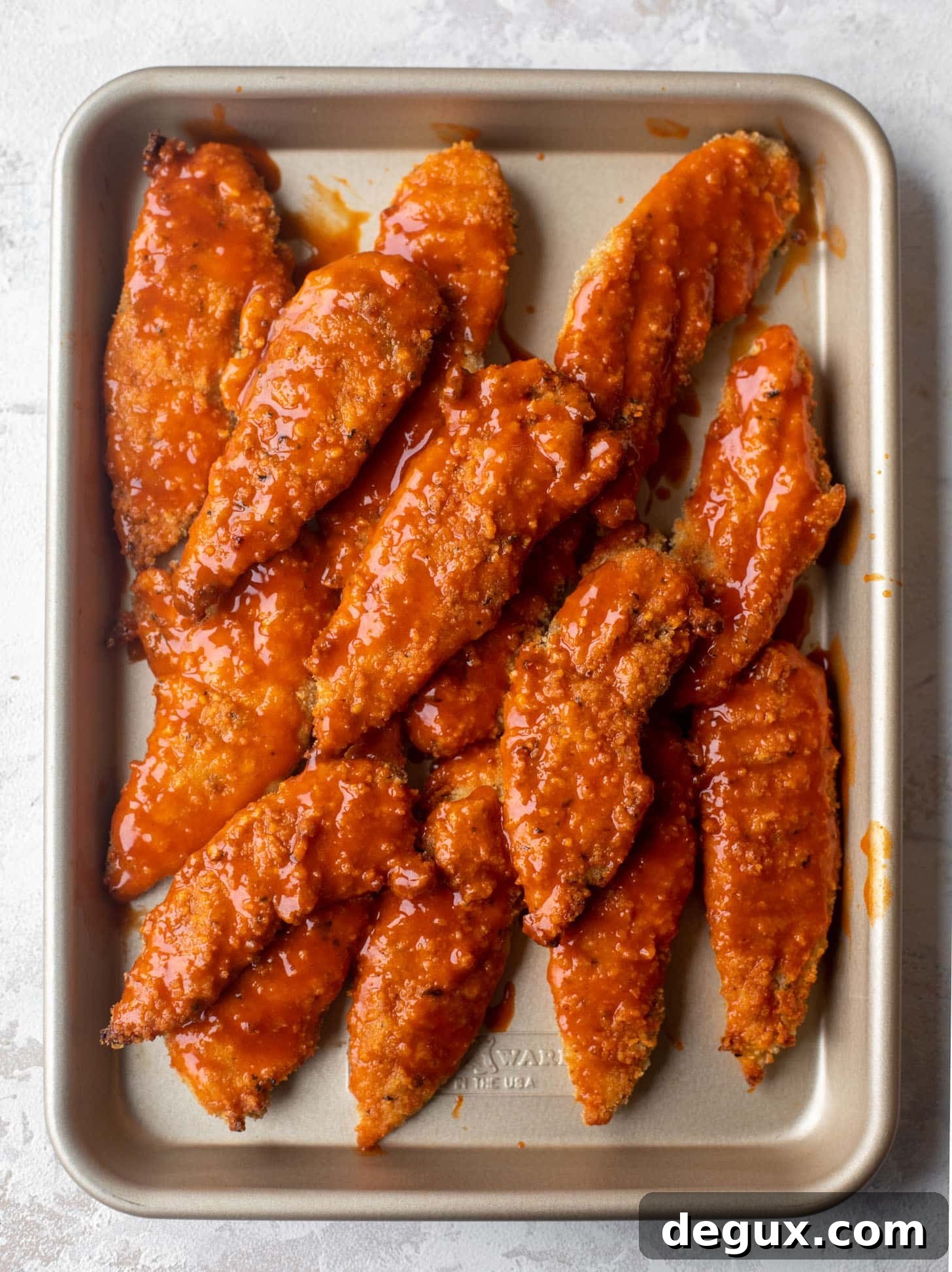 baked buffalo chicken on a sheet pan