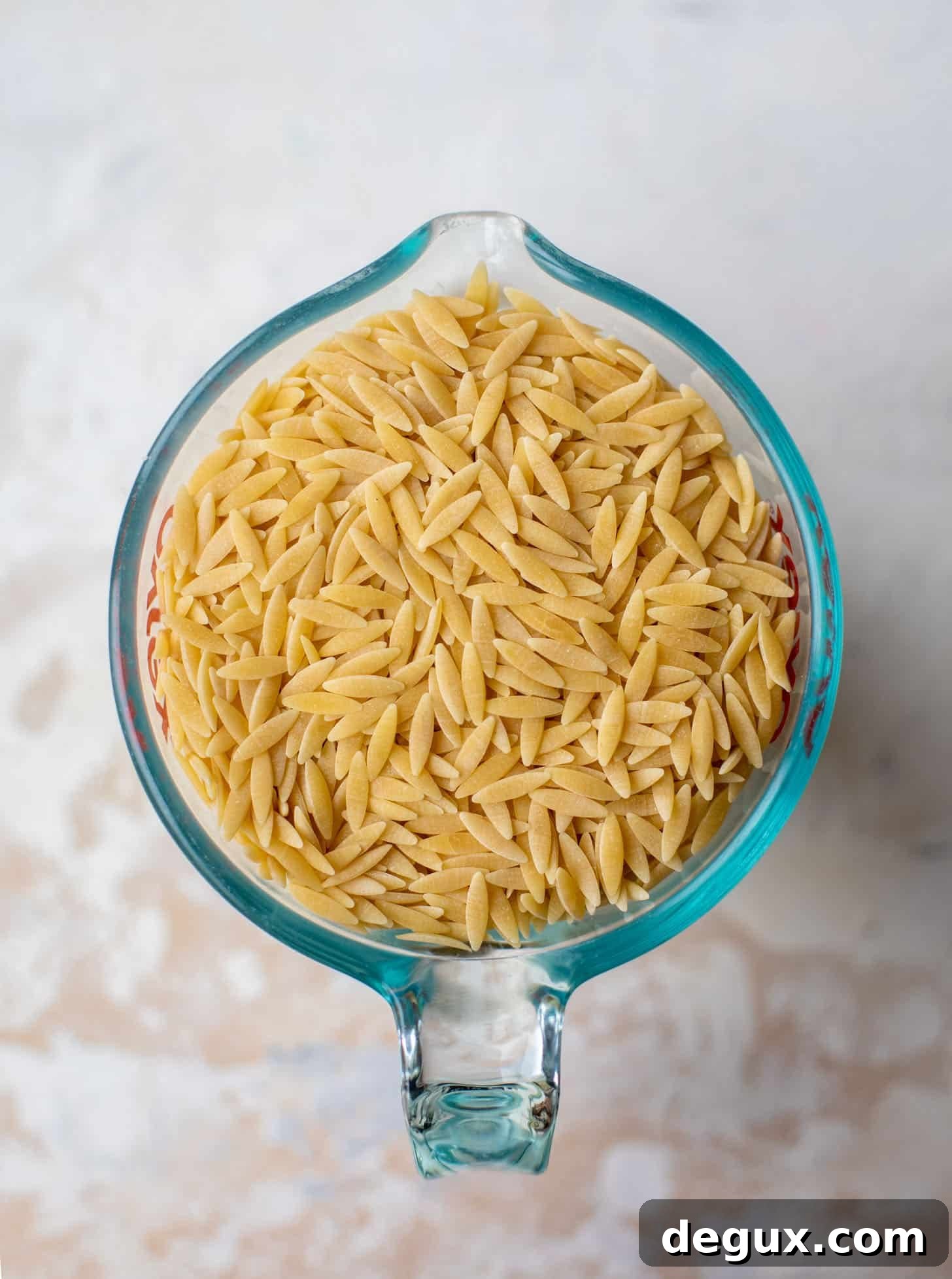 Parmesan Herb Orzo Recipe — Creamy Italian-Style Side Dish 3 orzo pasta in a measuring cup