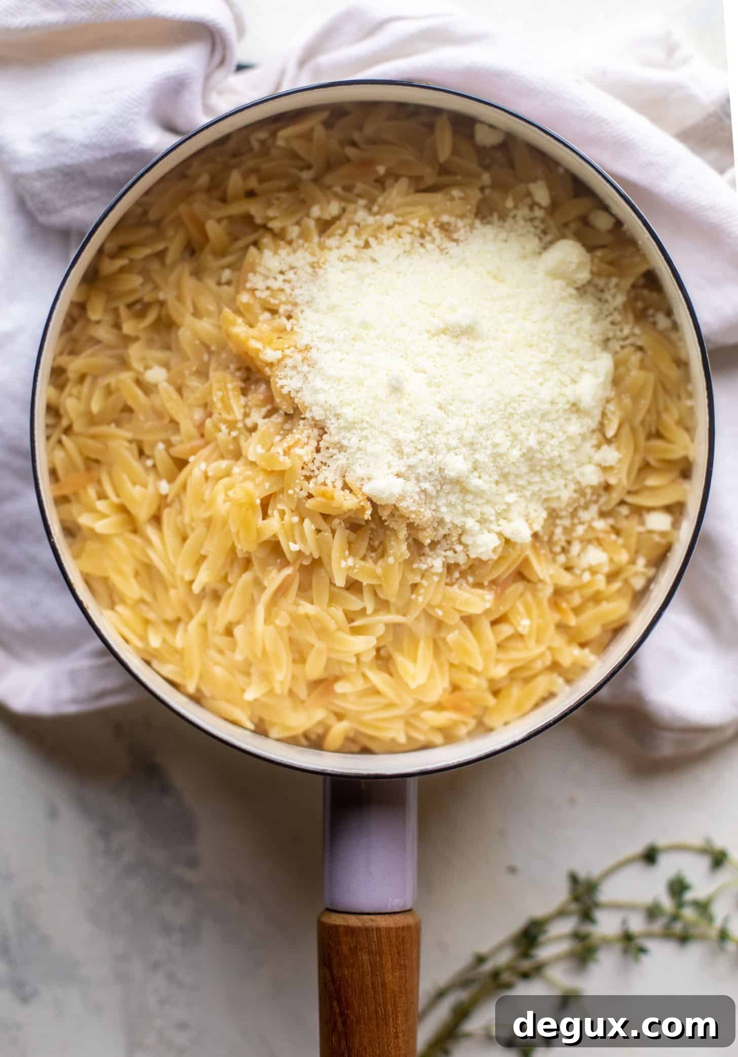 Parmesan Herb Orzo Recipe — Creamy Italian-Style Side Dish 4 cooked orzo in a pot with parmesan cheese