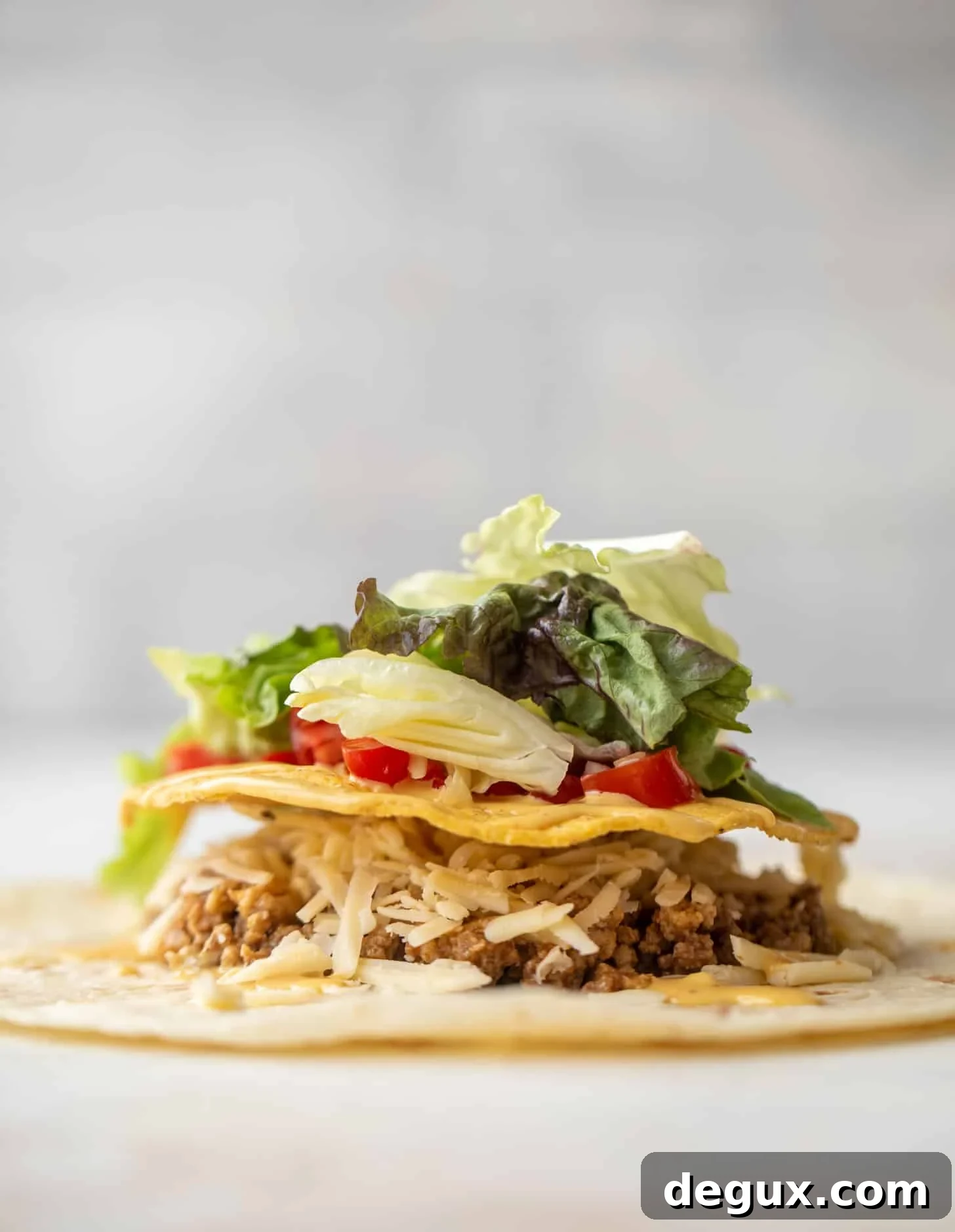 Crispy Cheeseburger Crunchwrap Recipe — Copycat Taco Bell Style 4 layering a cheeseburger crunchwrap