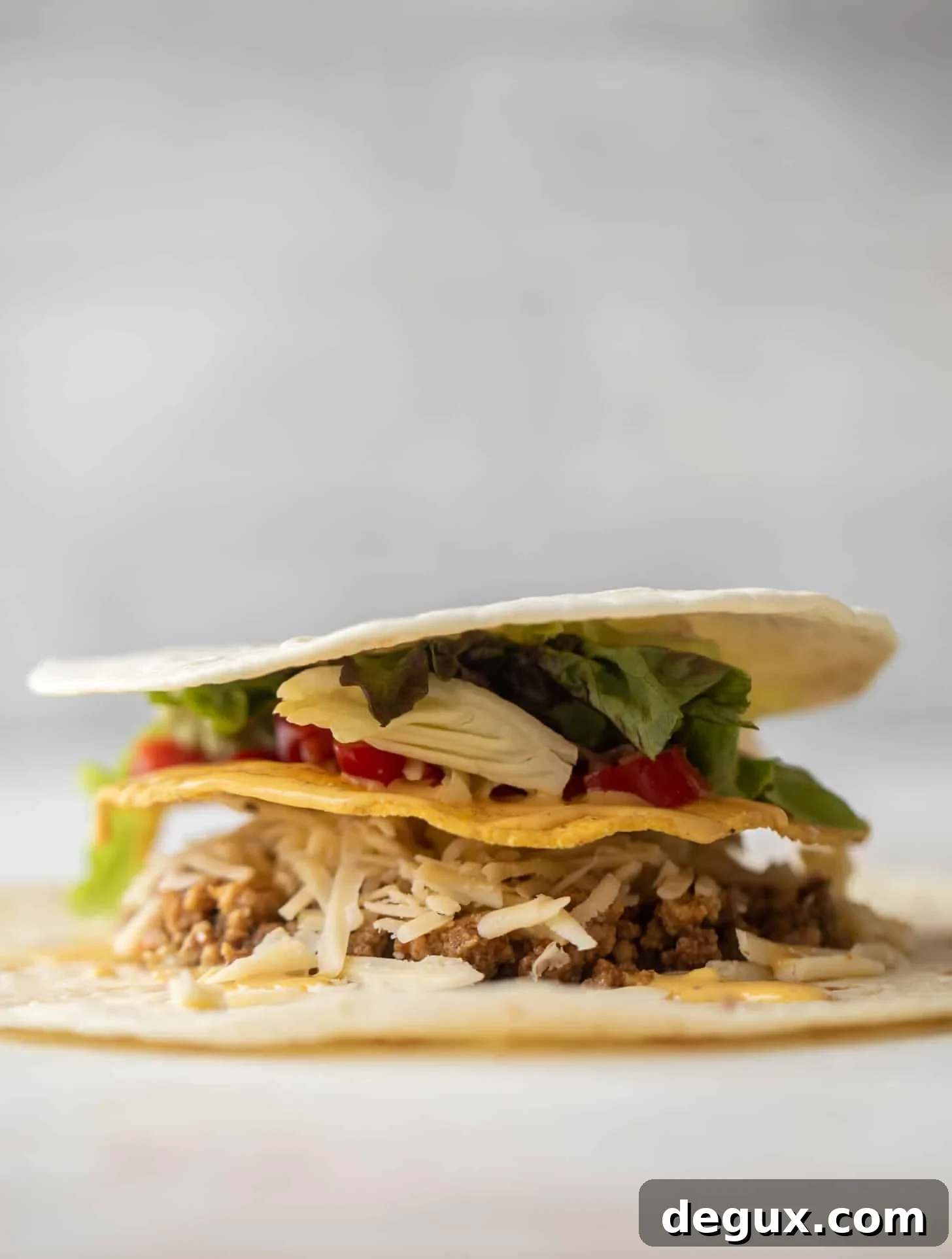 Crispy Cheeseburger Crunchwrap Recipe — Copycat Taco Bell Style 5 layering a cheeseburger crunchwrap