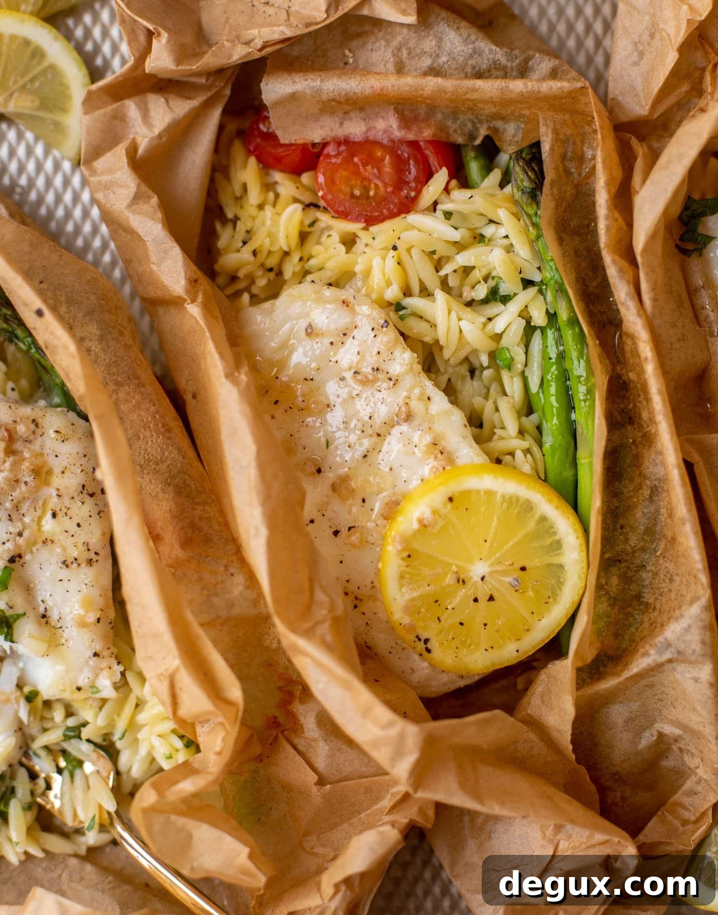 lemon garlic butter orzo and fish in parchment packet