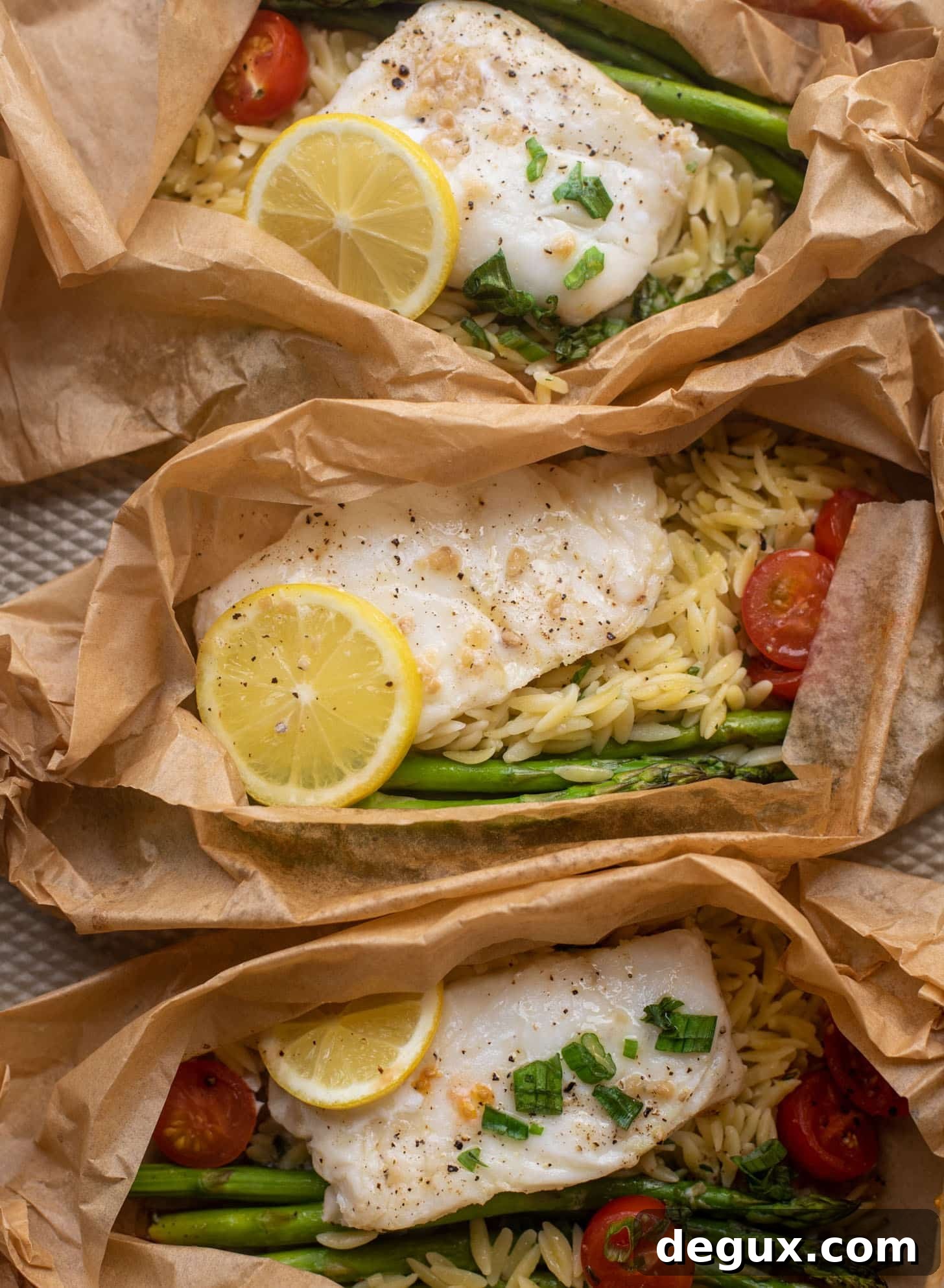 lemon garlic butter orzo and fish in parchment packet