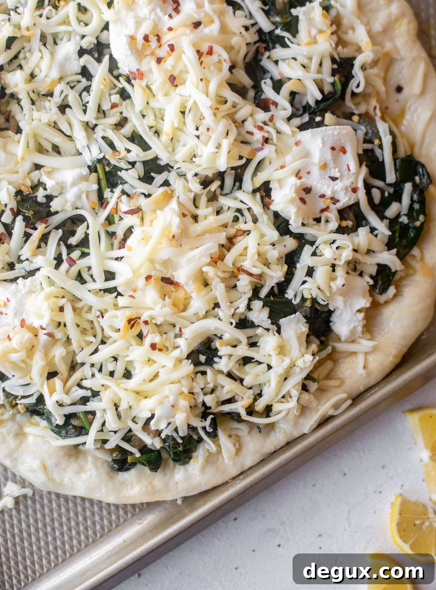 Smoked Mozzarella & Spinach Pizza Recipe for Crispy Crust 5 smoked mozzarella spinach pizza ready for the oven