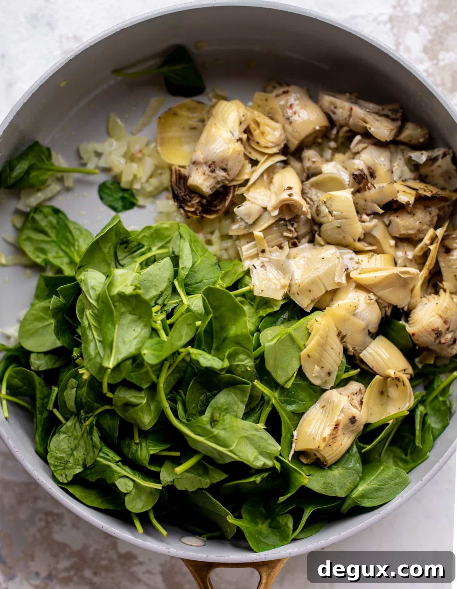spinach and artichokes in a skillet