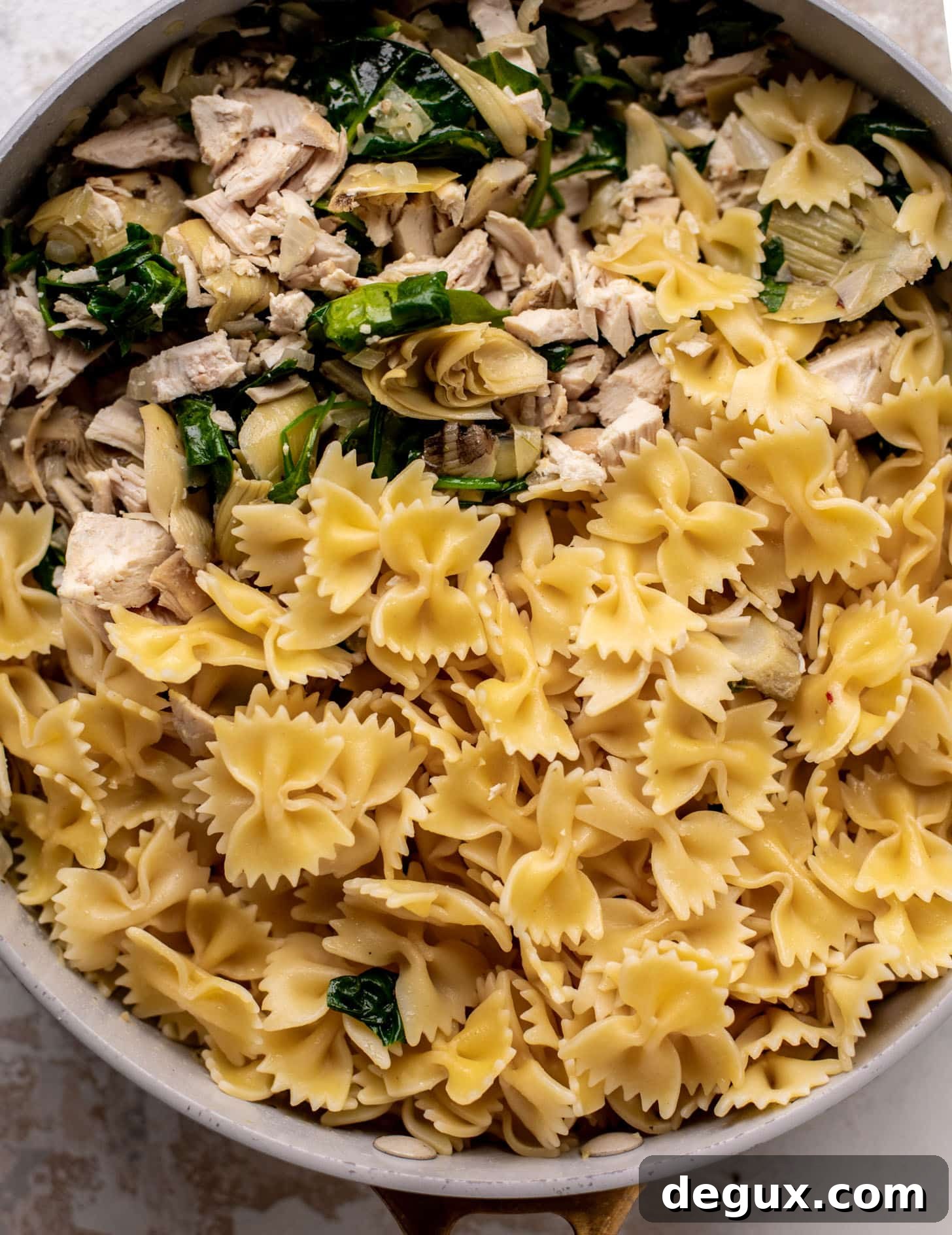 spinach artichoke chicken skillet lasagna ready for the oven