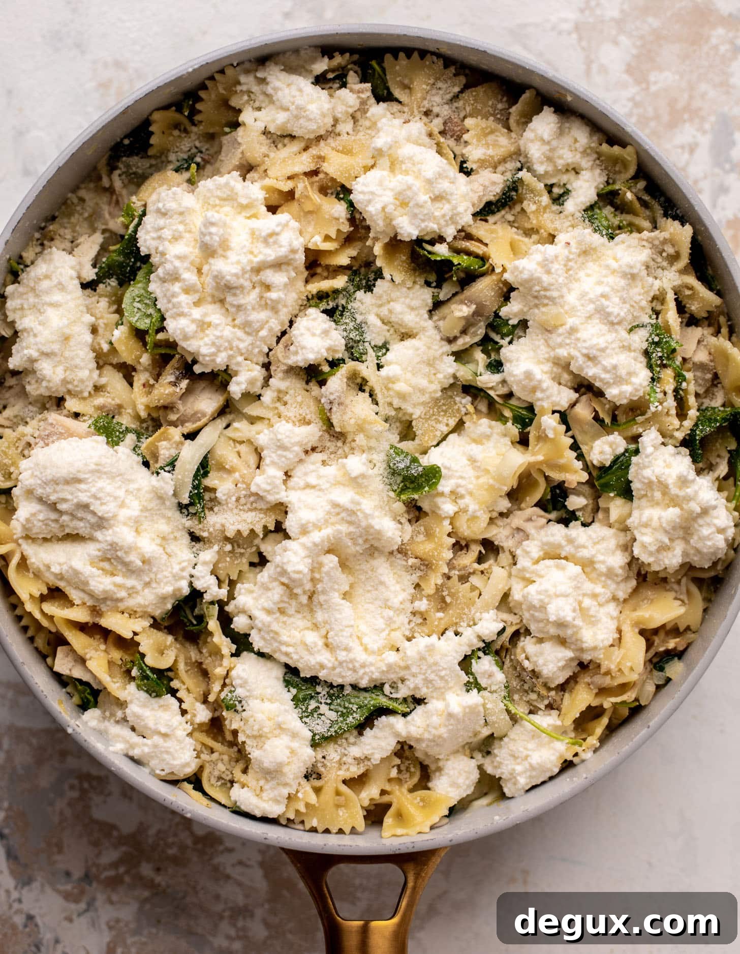spinach artichoke chicken skillet lasagna ready for the oven