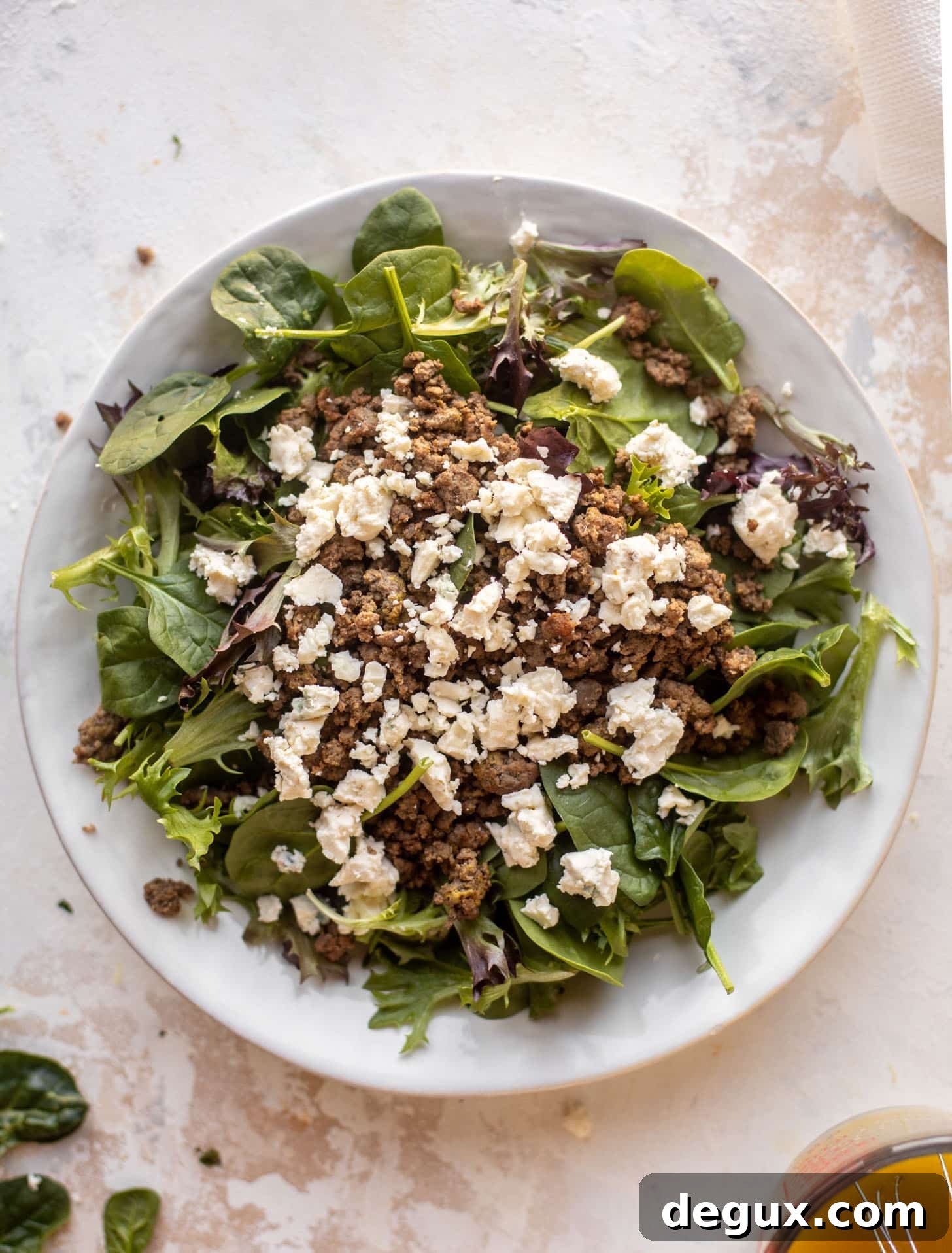 spring greens with burger and gorgonzola