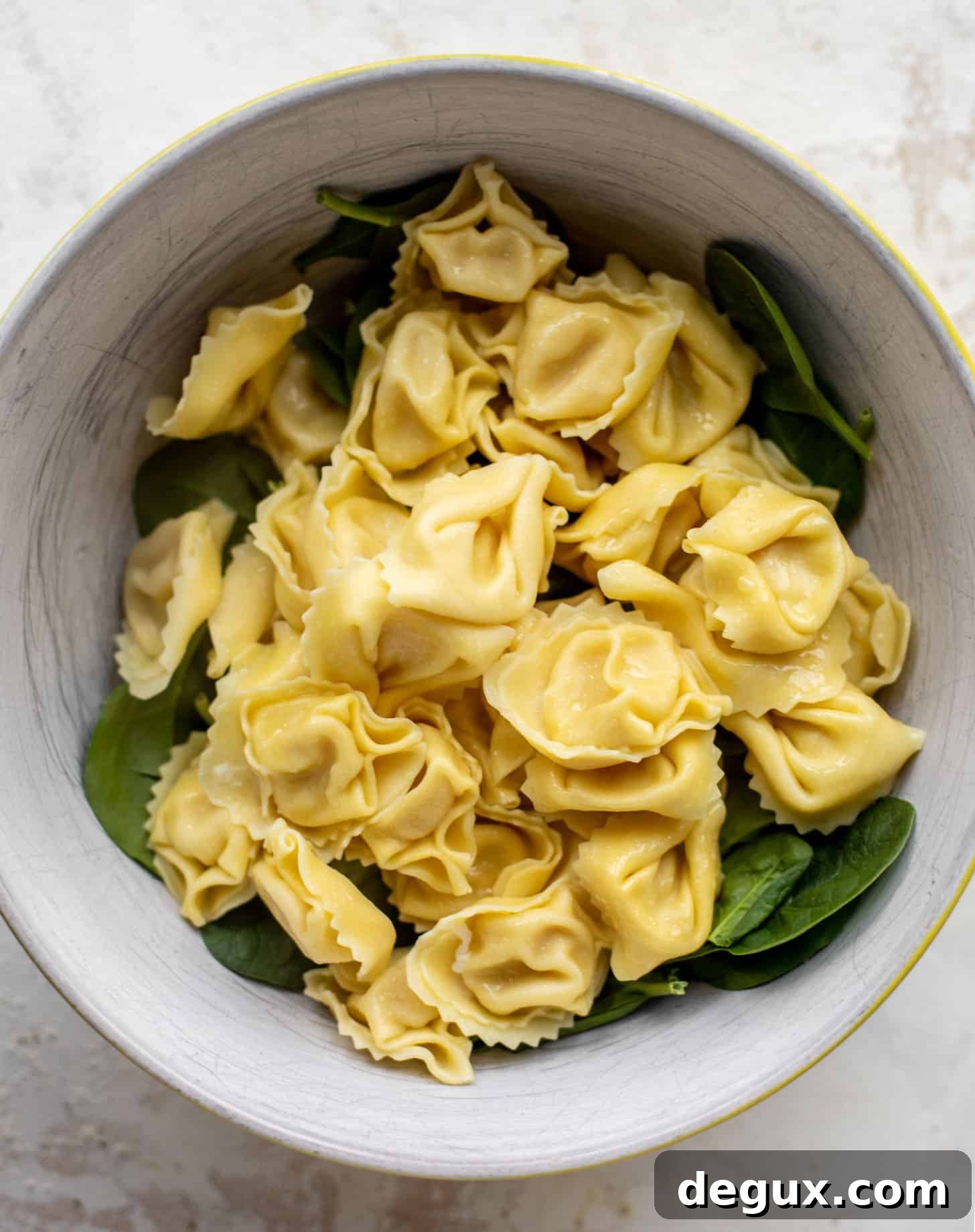 baby spinach and tortellini in a bowl