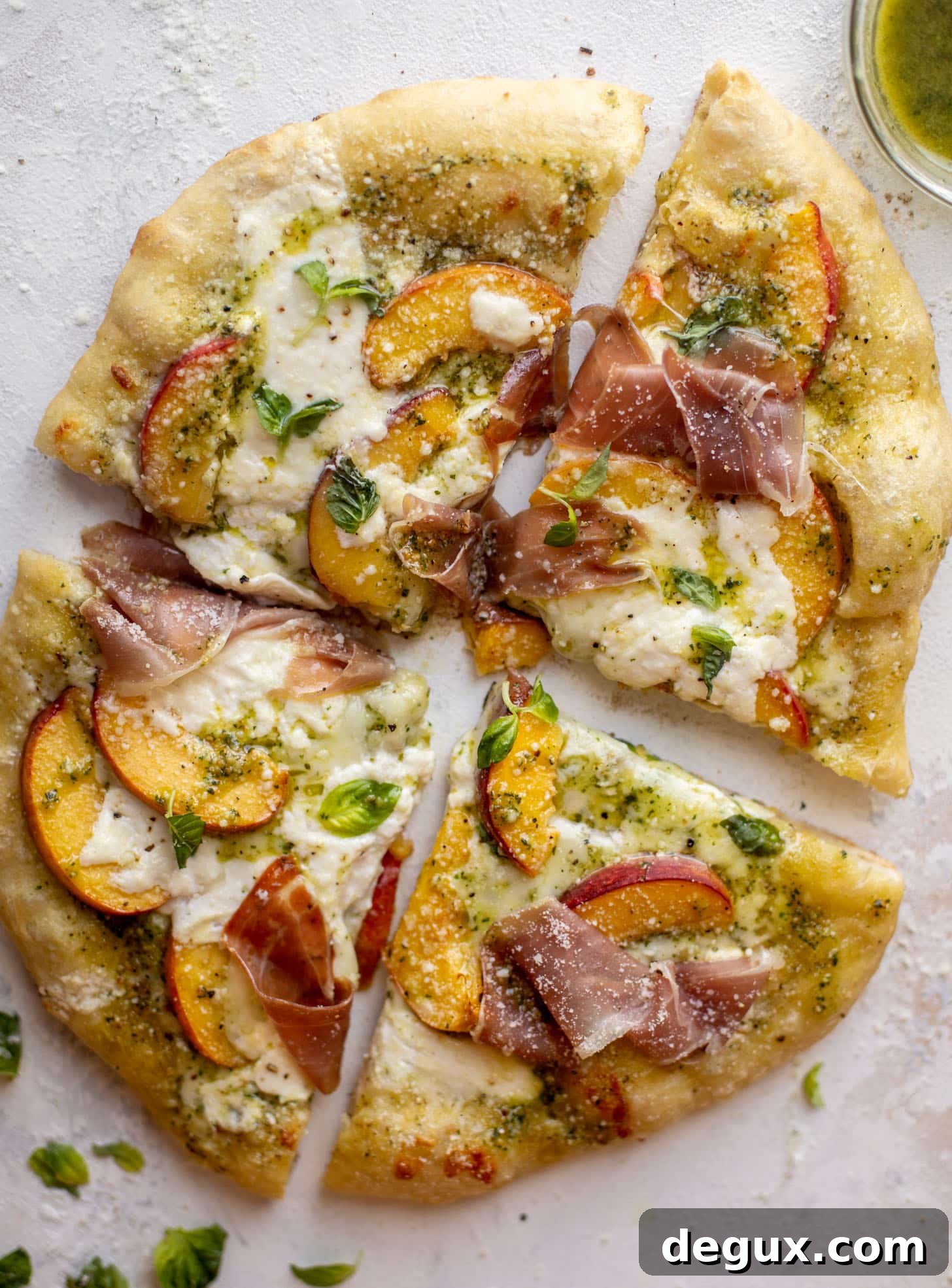 pesto peach pizza with prosciutto and burrata