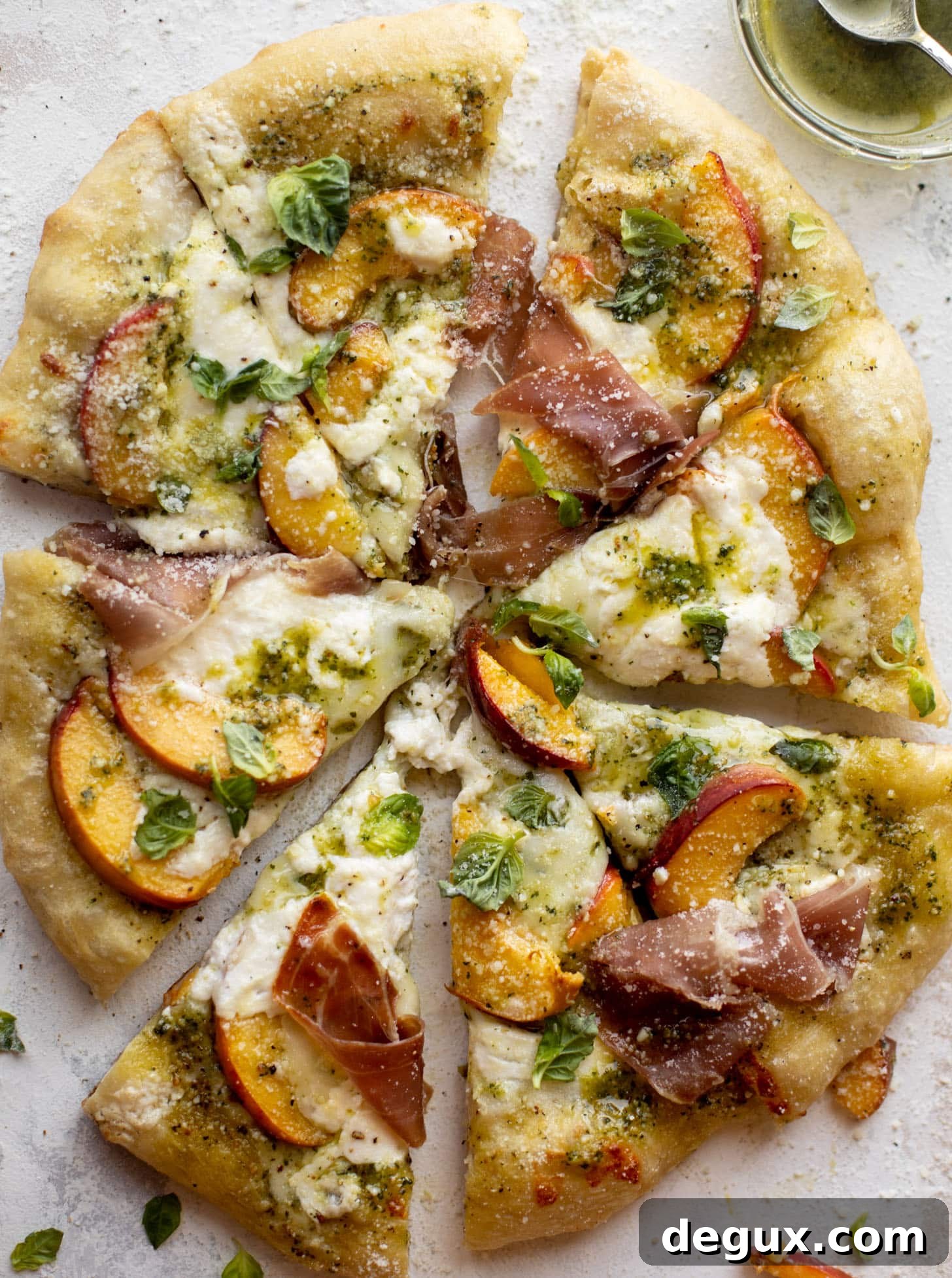 pesto peach pizza with prosciutto and burrata