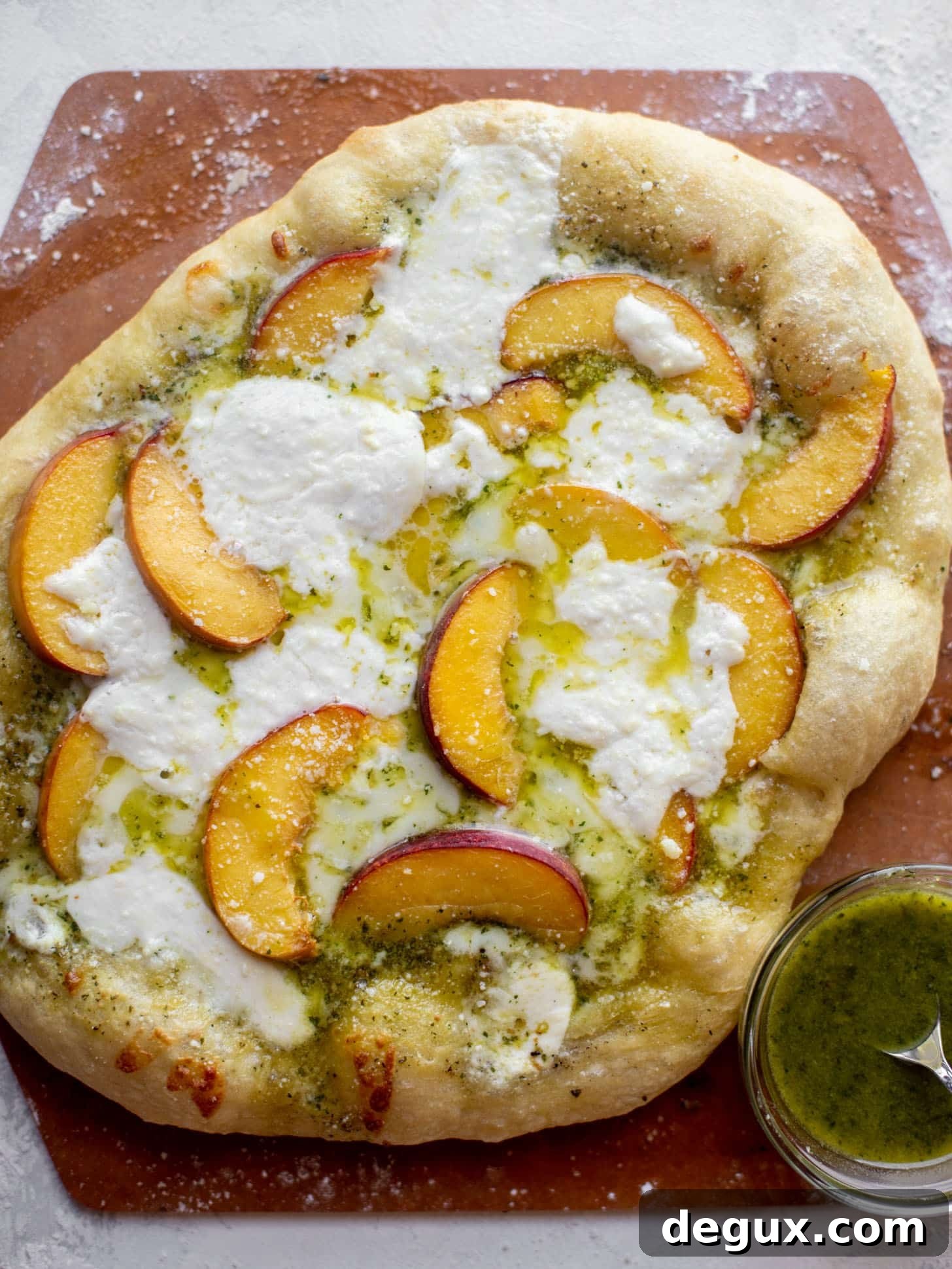 pesto peach pizza with prosciutto and burrata