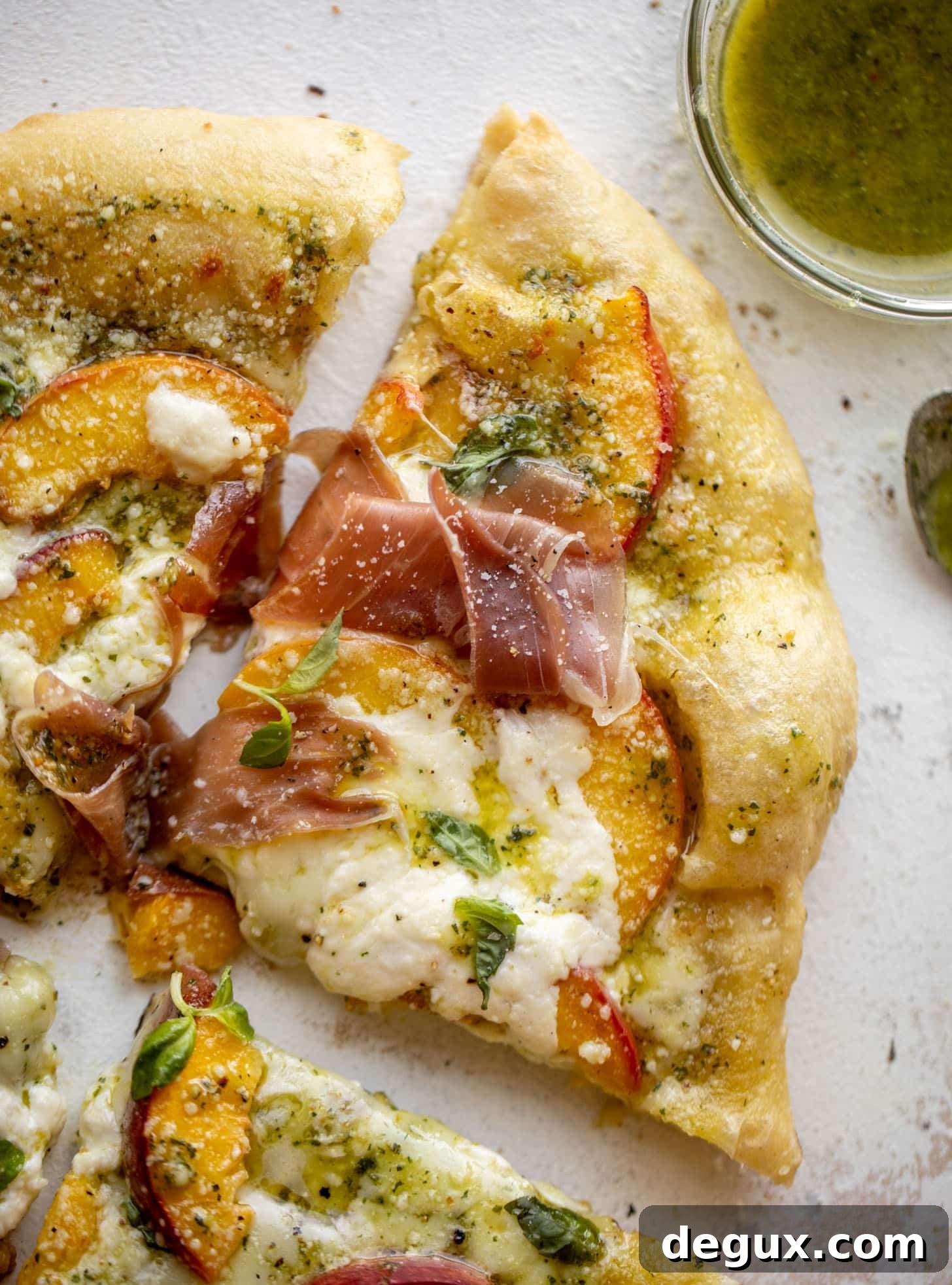 pesto peach pizza with prosciutto and burrata