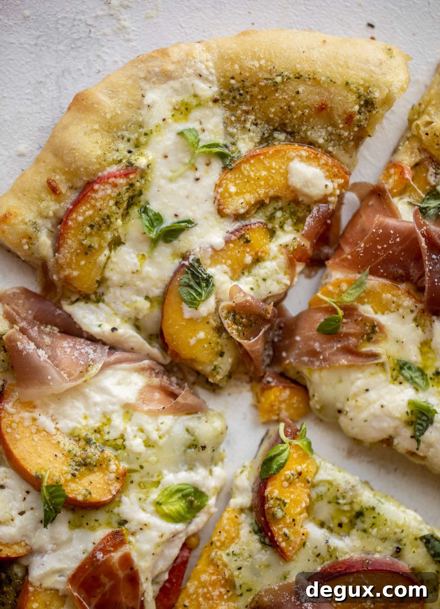 pesto peach pizza with prosciutto and burrata