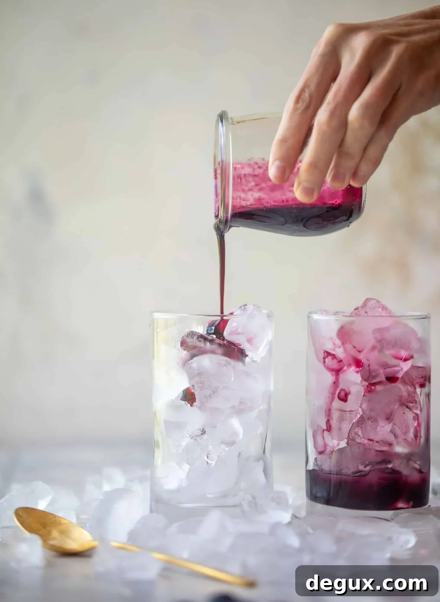 pouring blueberry lavender syrup over ice