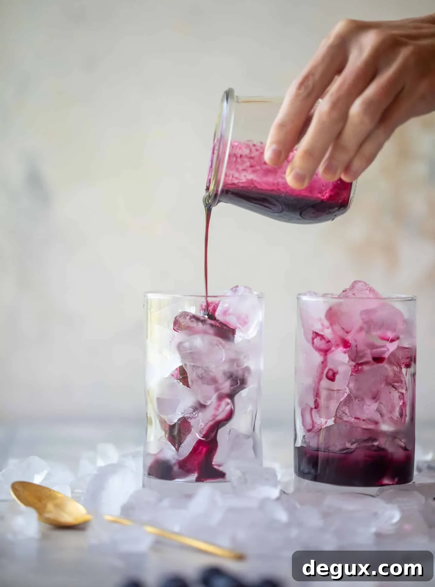 pouring blueberry lavender syrup over ice