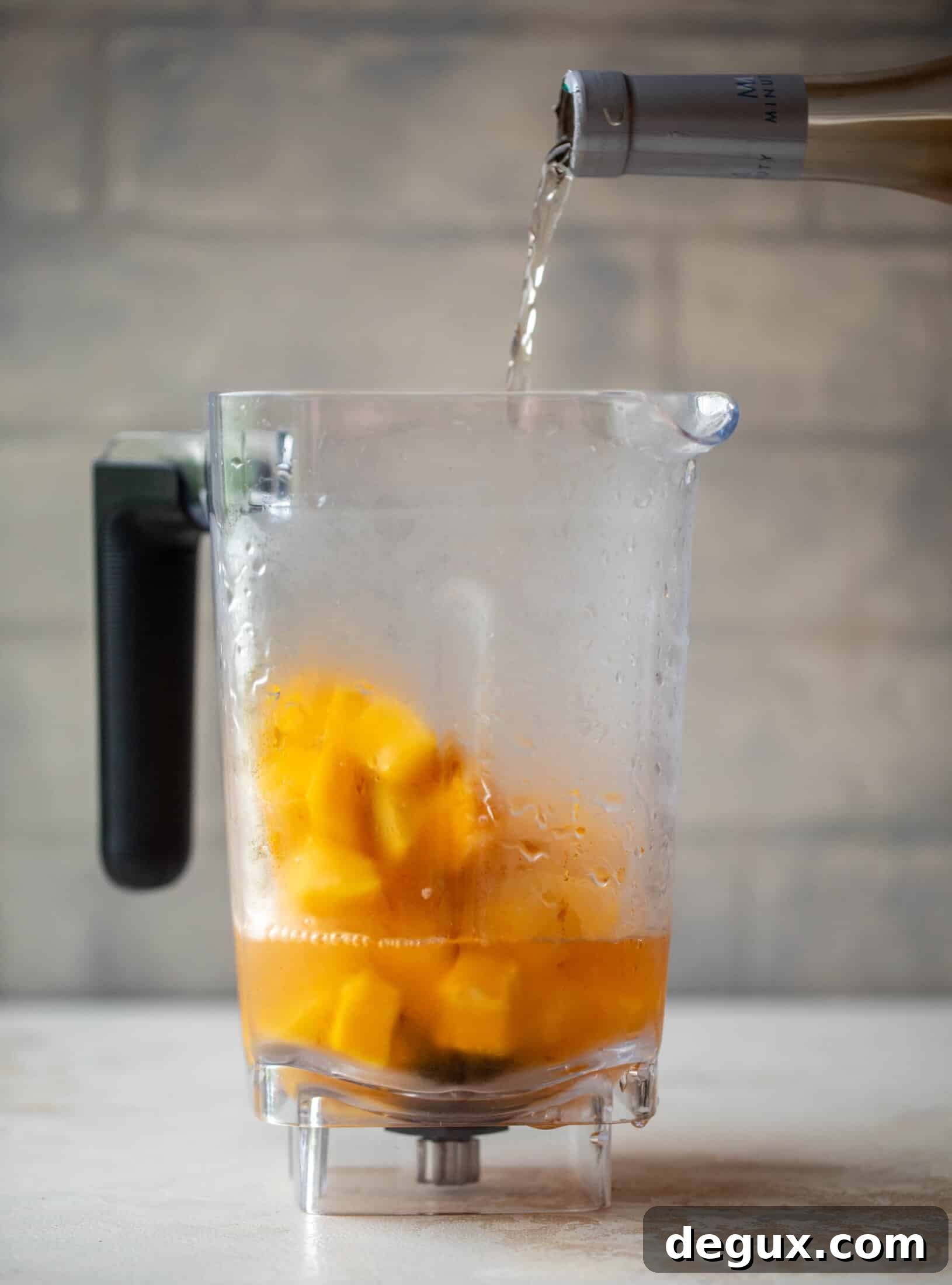 Mango Frosé: Refreshing Frozen Rosé Cocktail Recipe 3 Blending frozen mango and rosé