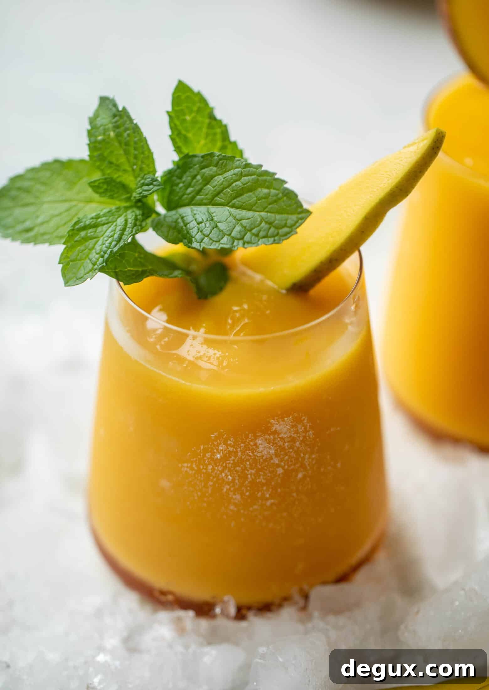 Mango Frosé: Refreshing Frozen Rosé Cocktail Recipe 6 Mango frosé in a glass with garnish