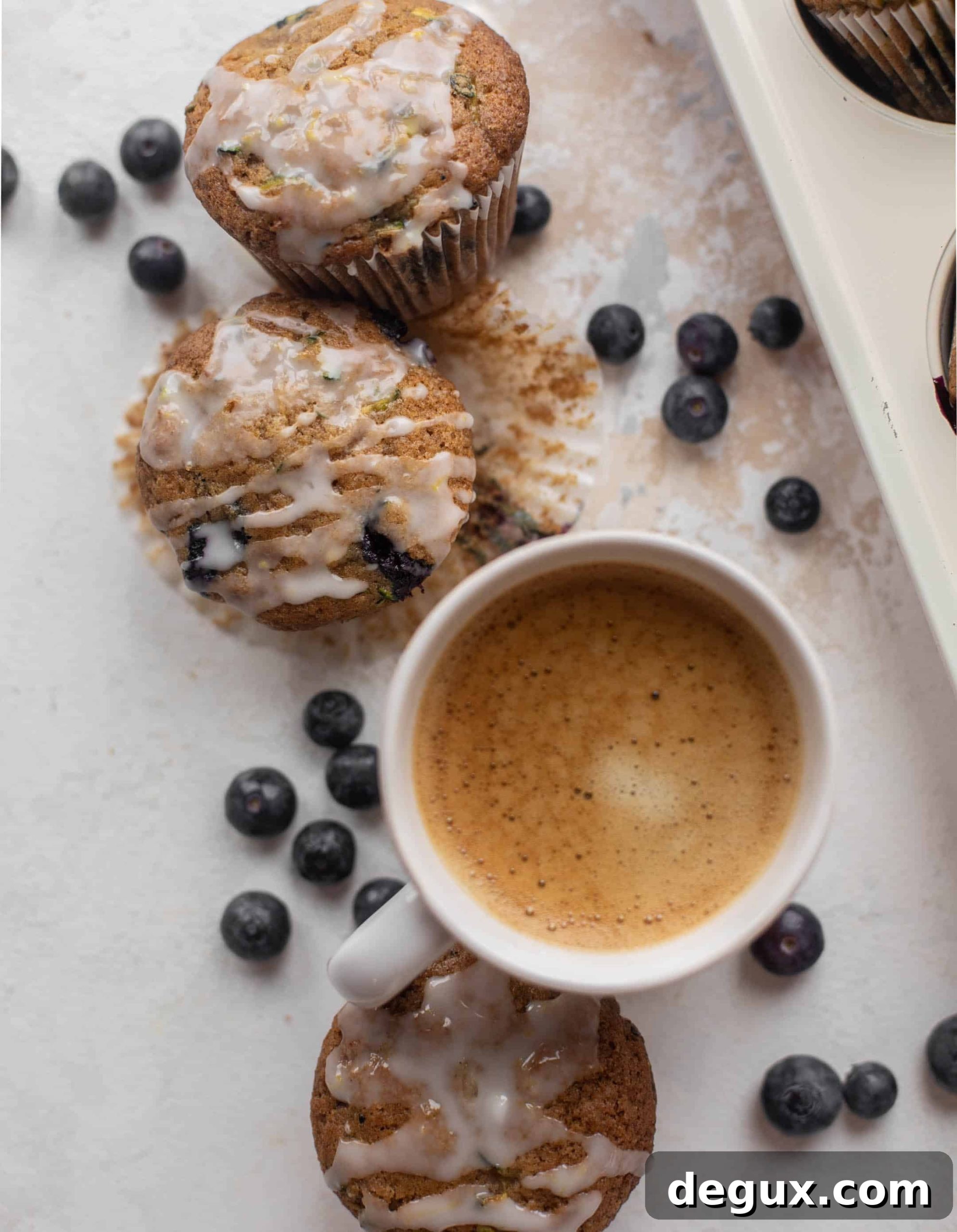 blueberry zucchini muffins with lemon glaze