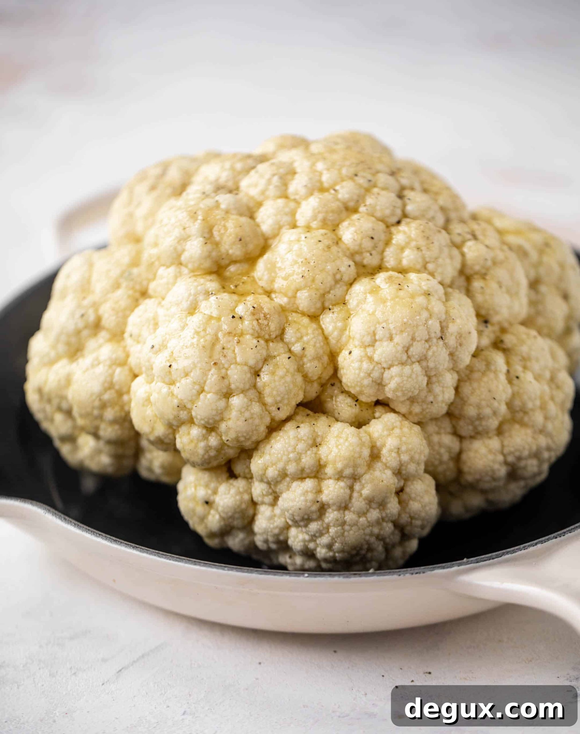 whole cauliflower in a skillet