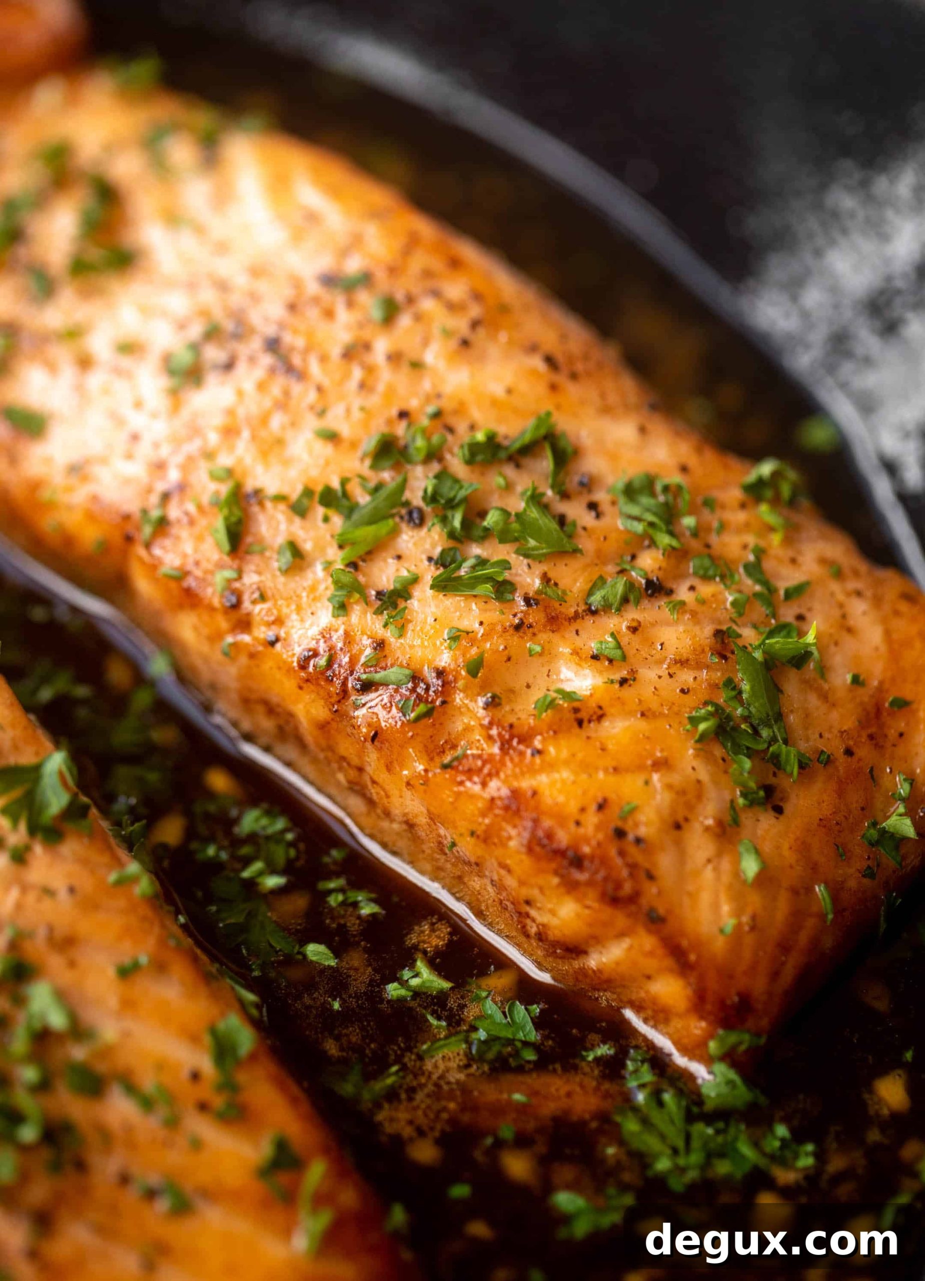 sticky garlic butter salmon in a skillet