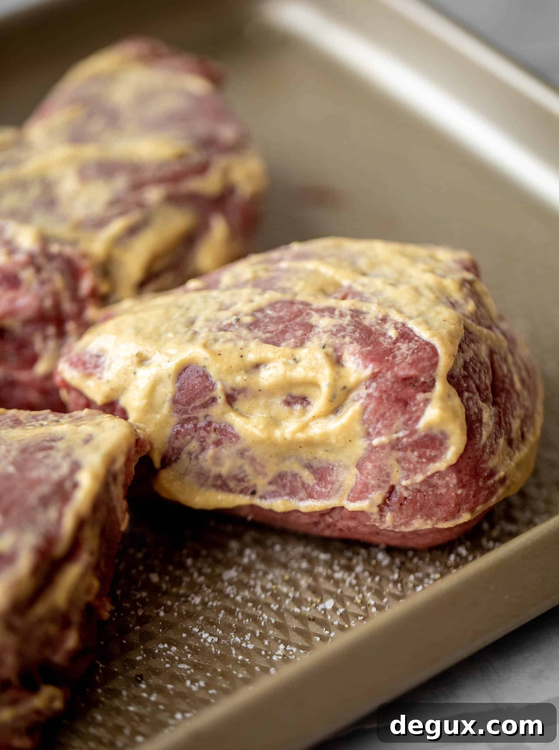 steak rubbed with dijon mustard