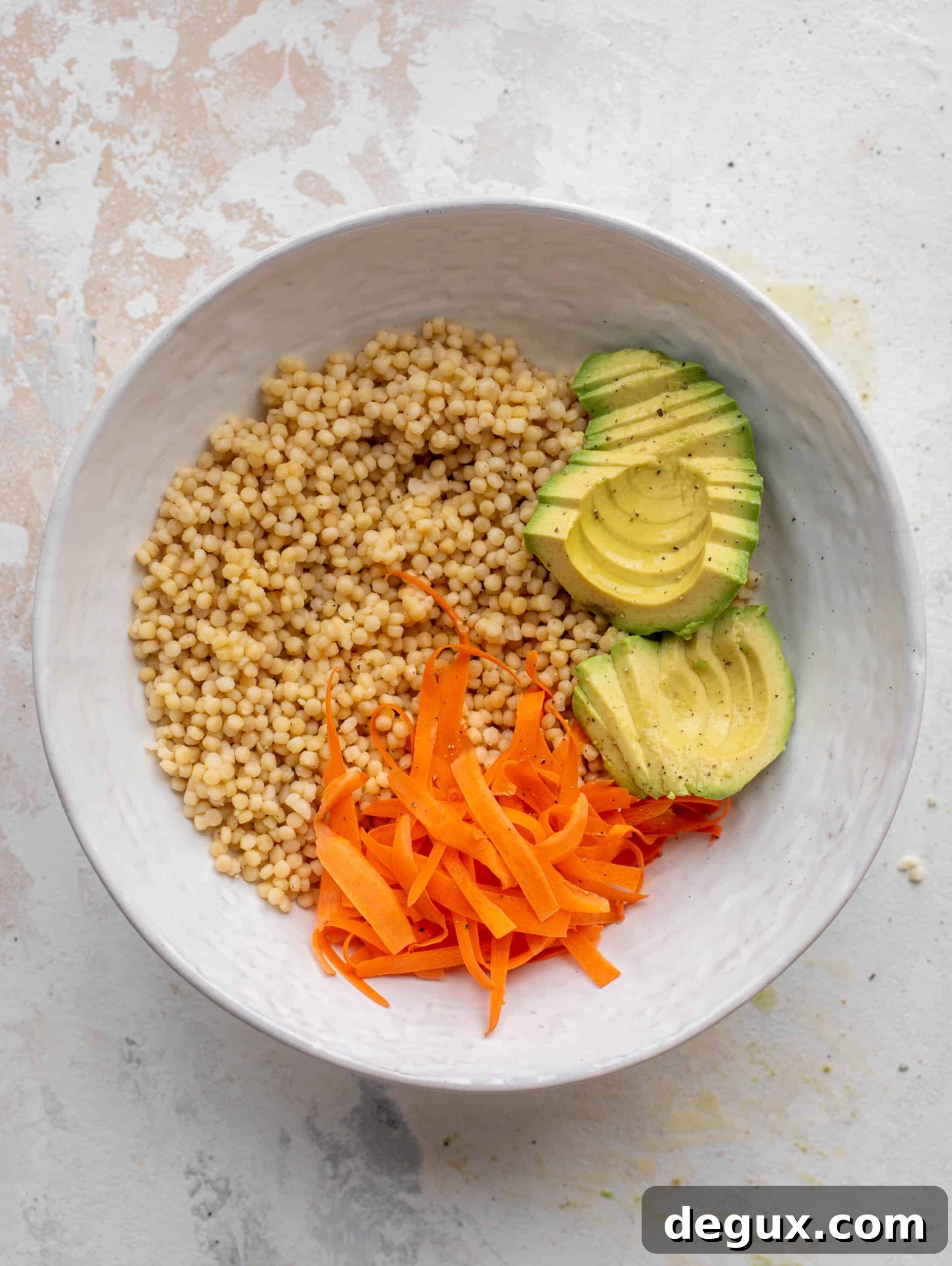 Sticky Salmon Couscous Bowls with Tangy Soy Glaze 6 couscous with carrots ribbons and avocado