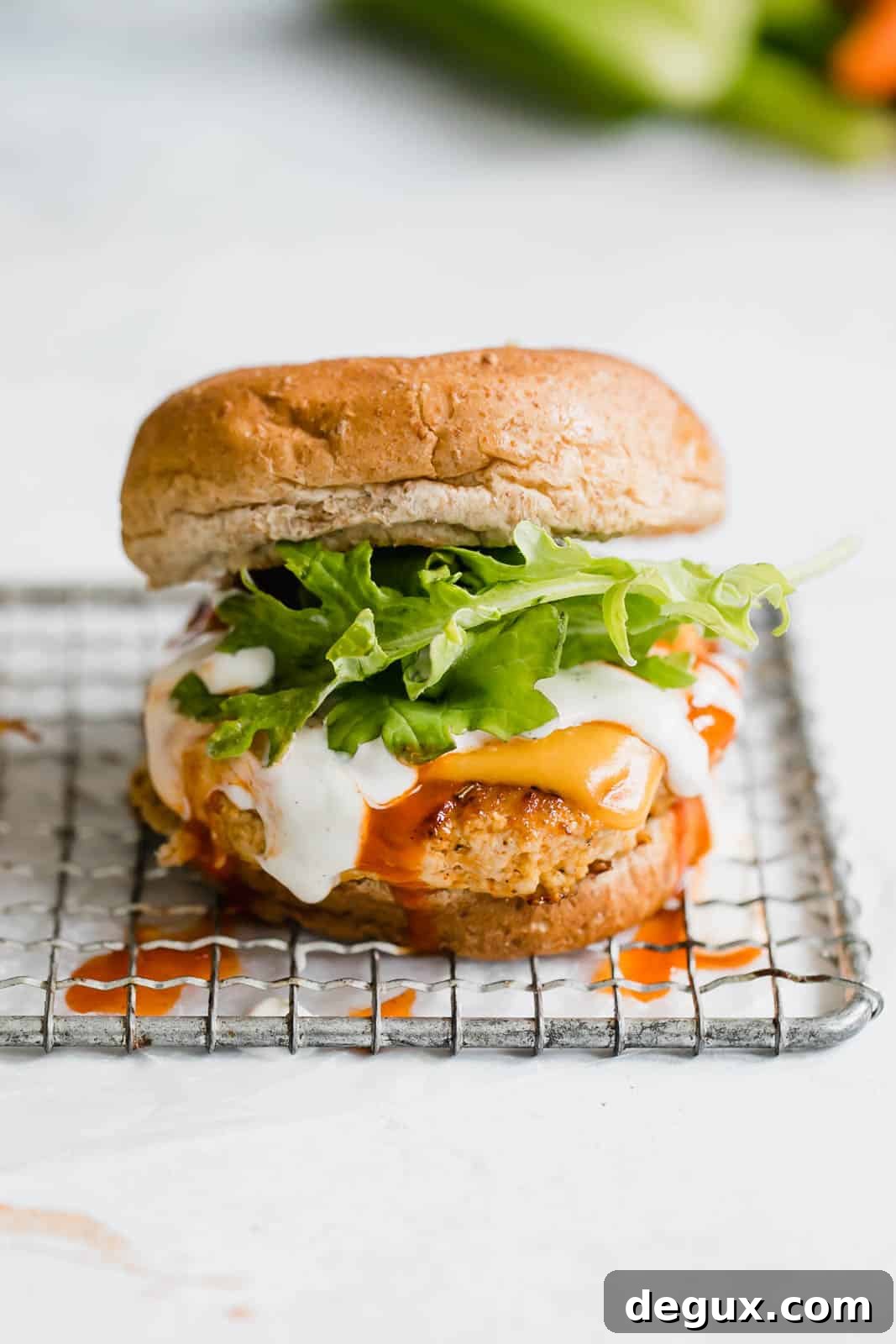 Spicy Buffalo Chicken Burger Recipe with Blue Cheese Slaw 3 buffalo chicken burgers I howsweeteats.com #buffalo #chicken #burgers
