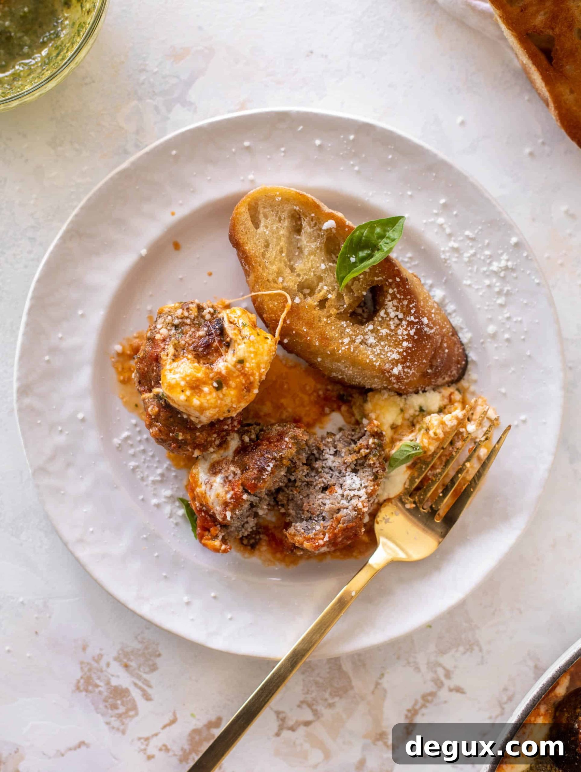 Baked Pesto Meatballs with Burrata and Melted Cheese 12 cheesy baked pesto meatballs with burrata