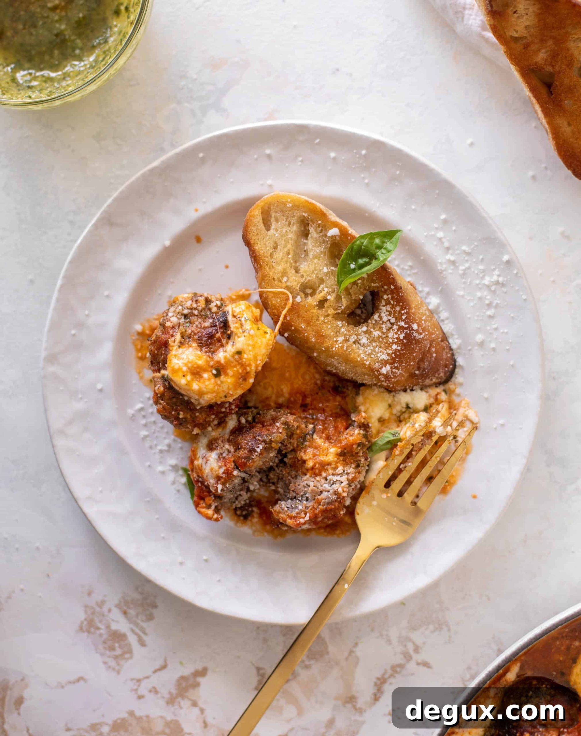 Baked Pesto Meatballs with Burrata and Melted Cheese 10 cheesy baked pesto meatballs with burrata