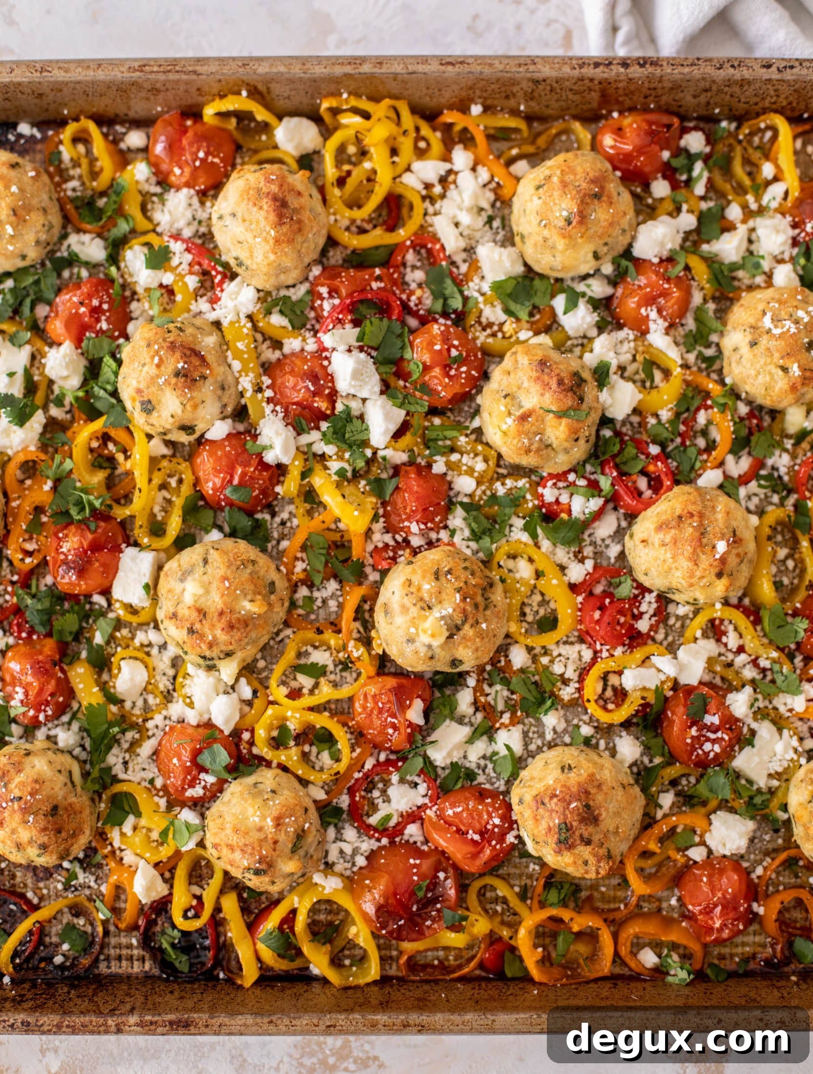 sheet pan chicken meatballs with tomatoes and feta