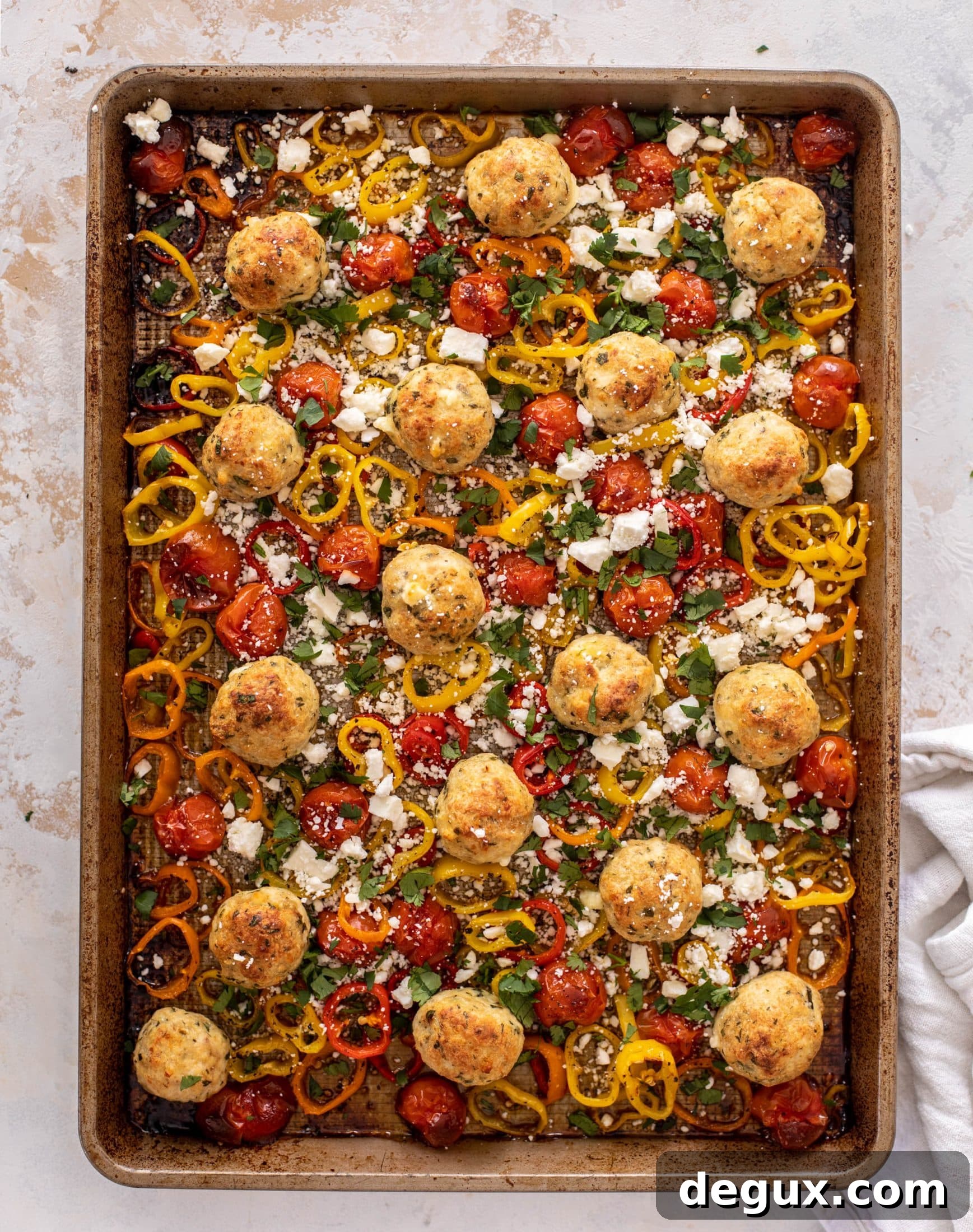 sheet pan chicken meatballs with tomatoes and feta