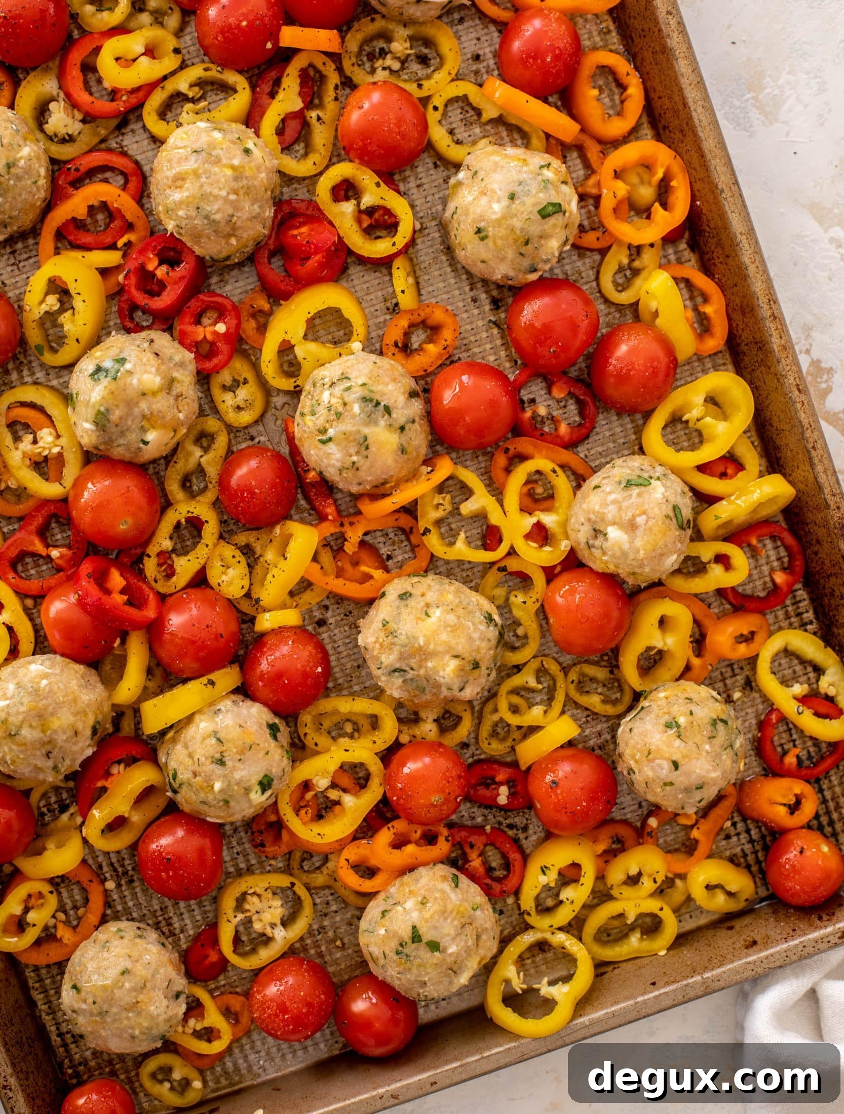 sheet pan chicken meatballs with tomatoes and feta