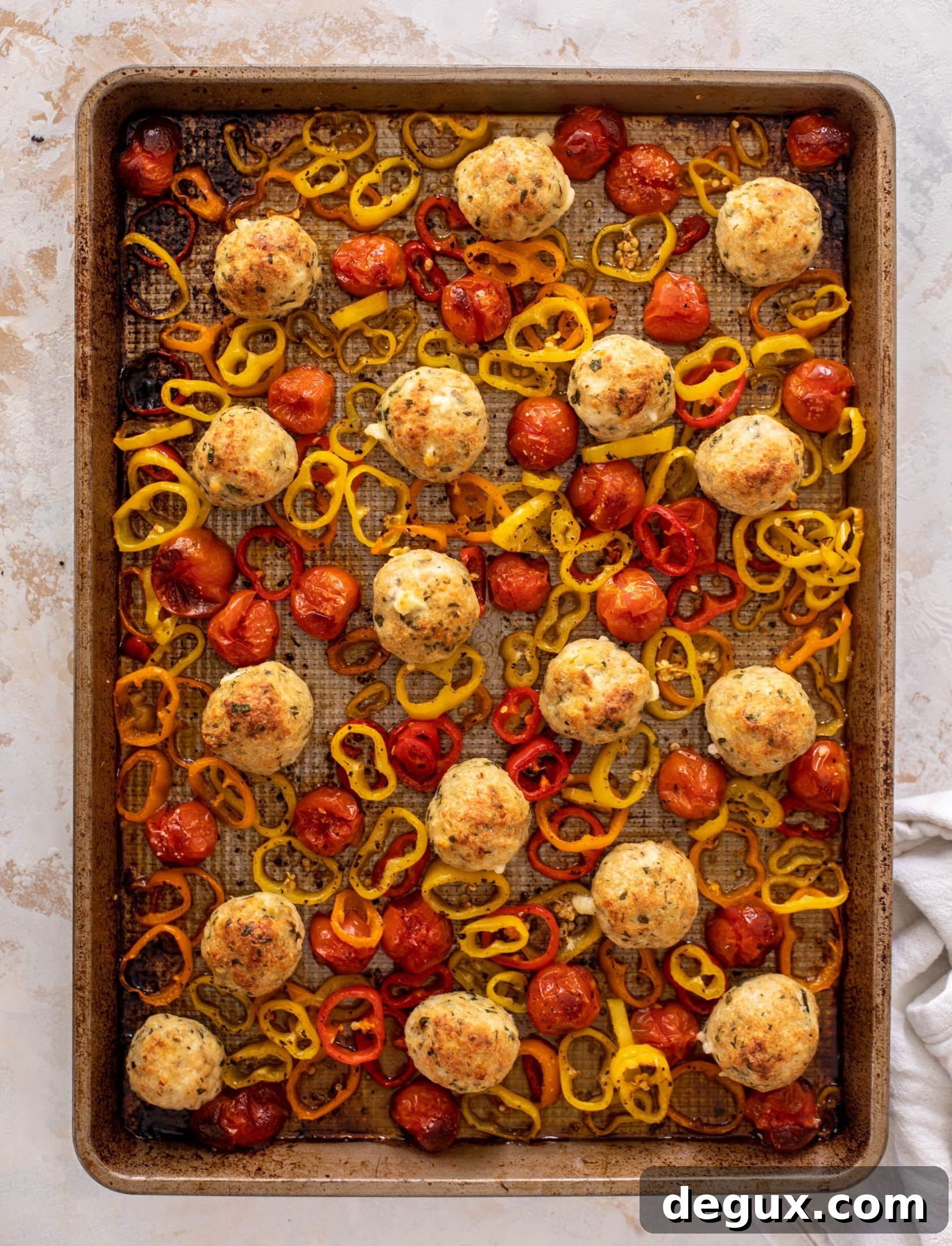 sheet pan chicken meatballs with tomatoes and feta